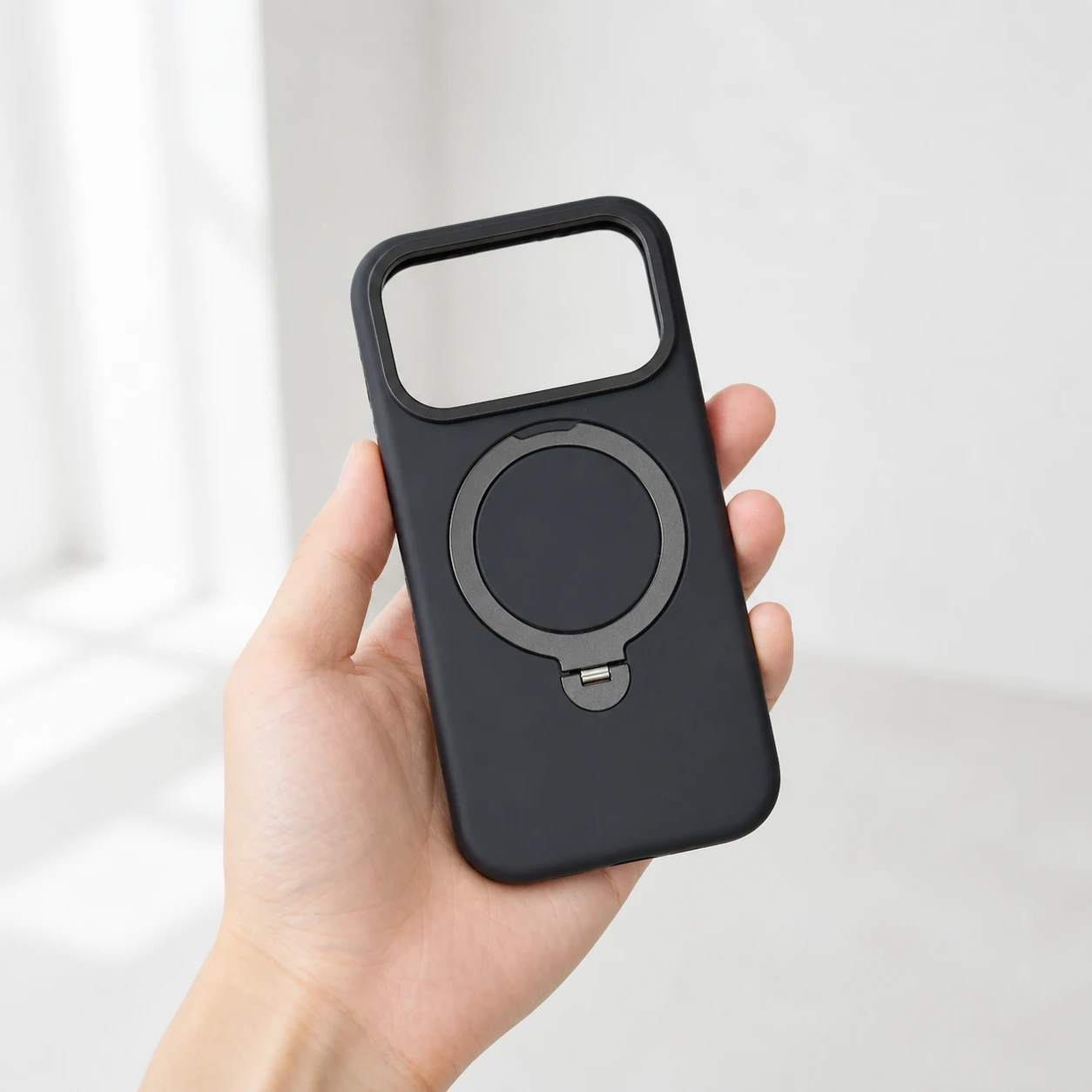 Black silicone ring case held in one hand